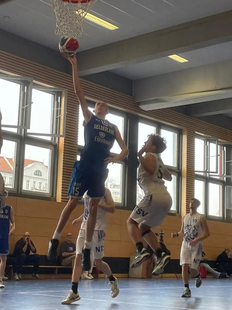A United Basketball player rises high for a lay-up during a game in Berlin.
