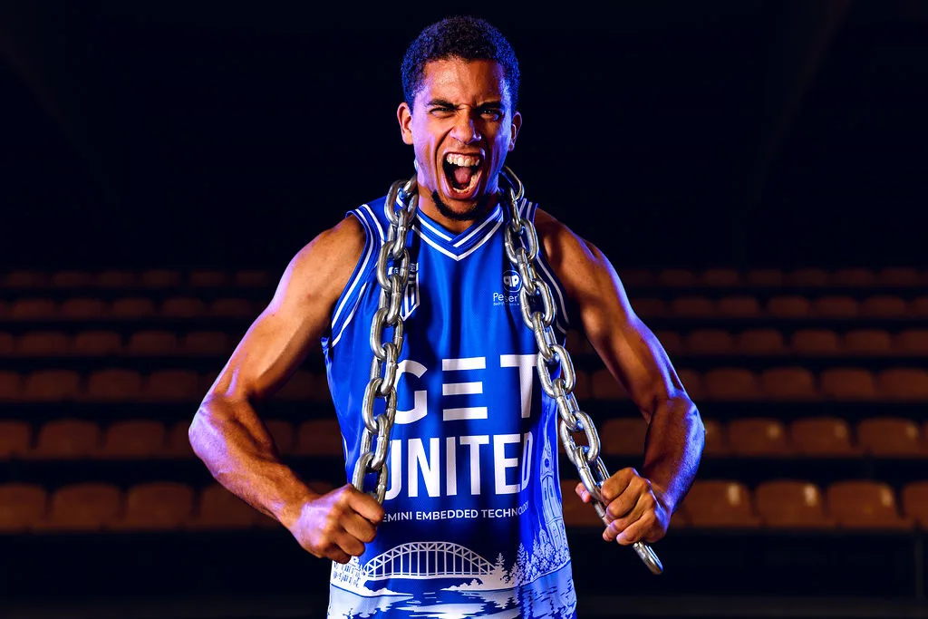 Robin Simonis in GET United kit with a chain around his neck, roaring at the camera